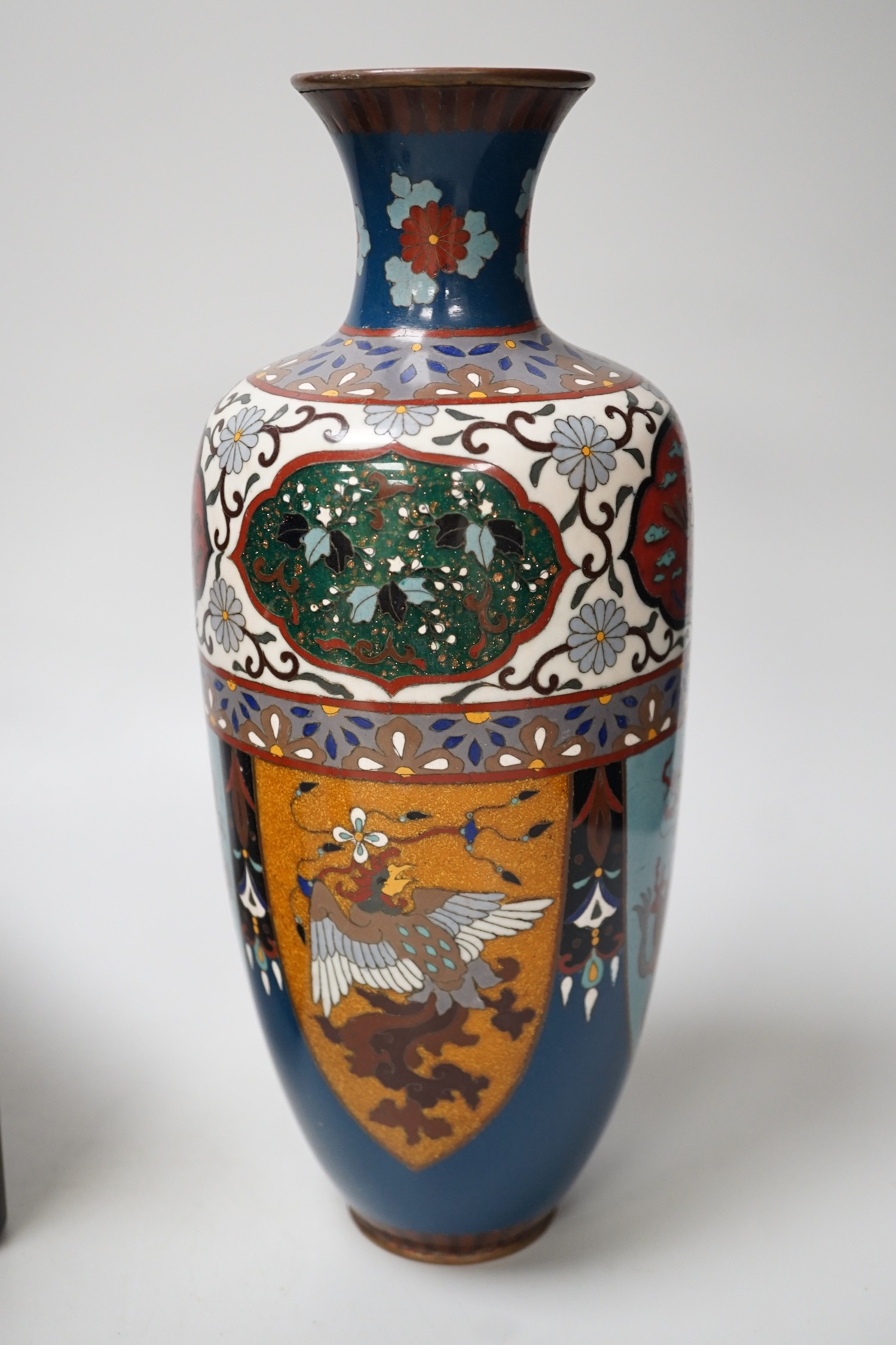 A large Japanese cloisonné enamel vase, 30.5cm high, a similar jar and cover and a Japanese lacquered tiered box with 3-4 drawers. Tree design in gold lacquer.